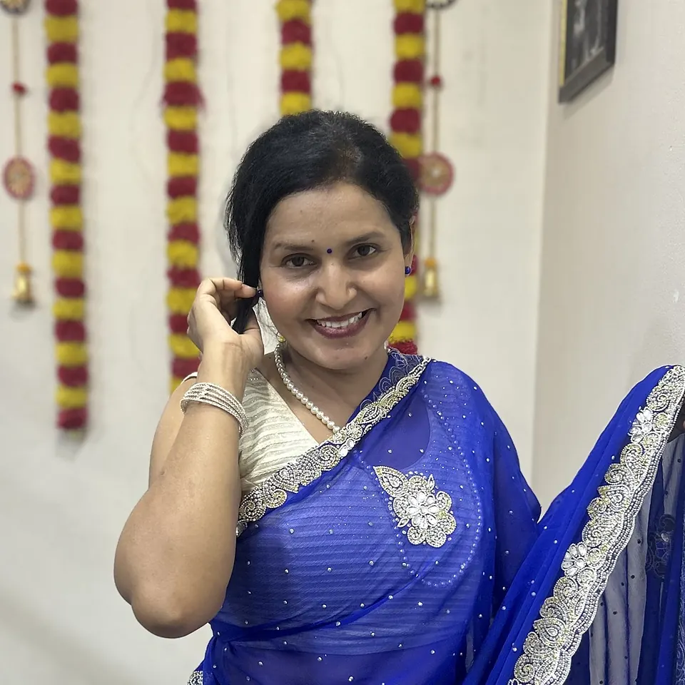 Dr Smita Wagh, the host, smiling, in a blue saree